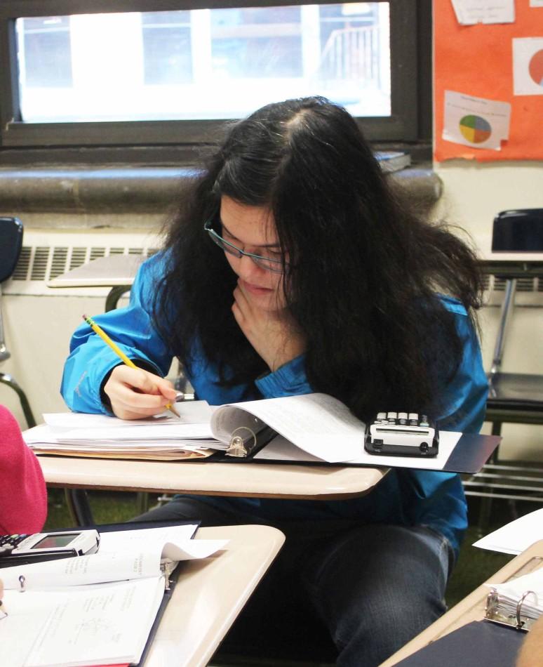 Olivia Larsen, sophomore, works on a geometry problem at practice. 