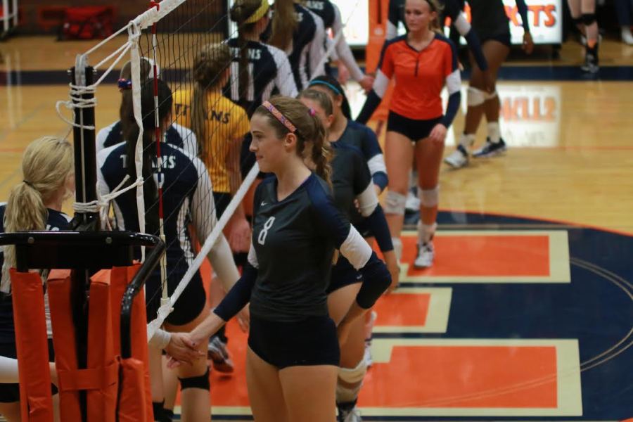 The team shakes hands with New Trier after the game.