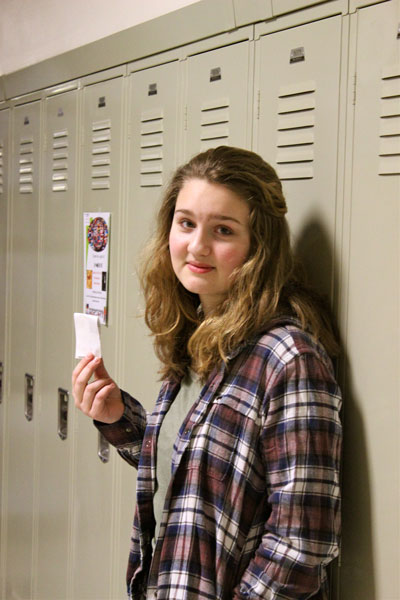 Junior Ceci Hansen holds her tardy pass. 