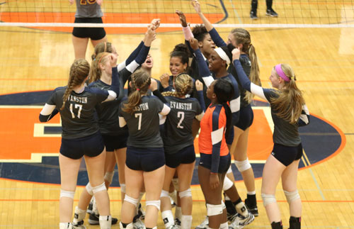 The girls volleyball team huddles together after a game. 