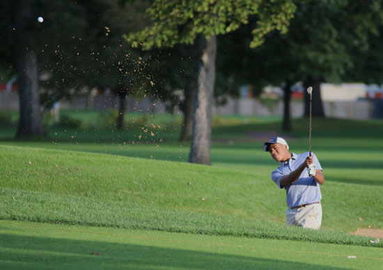 Robert James chips the ball onto the green during a game against New Trier. 