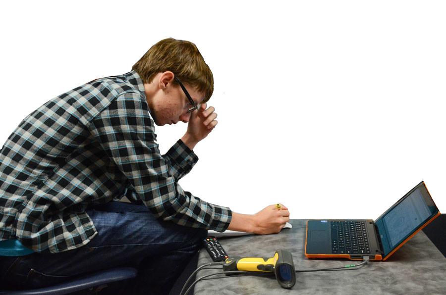 A student does repairs on a Chromebook.