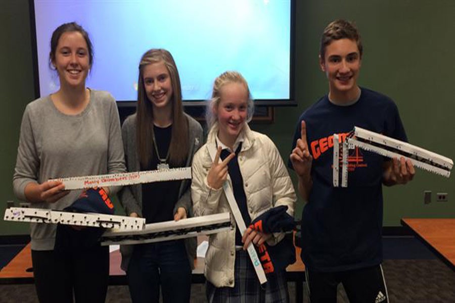 Top bridge builders in the ETHS Straw Bridge Building and Breaking Contest pose with their bridges. From left, Becca Miller, Leah Altman, Arden Cusick and Joe Leibforth.