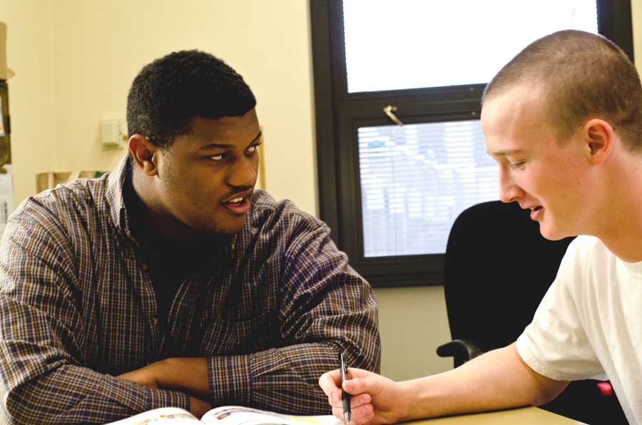 Tim Brewer helps Frank Brice Hartley with his homework.