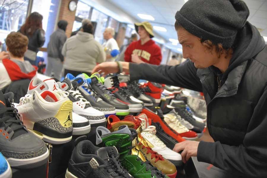 A vendor at last year's Sneaker-con prepares shoes for resale.