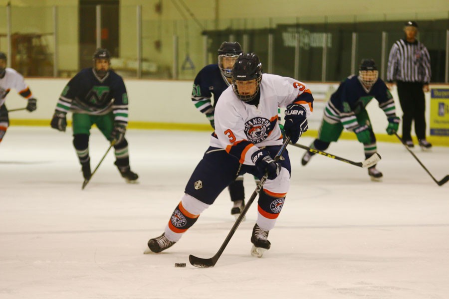 Sophomore Joe Epler skates past a New Trier defenseman. 