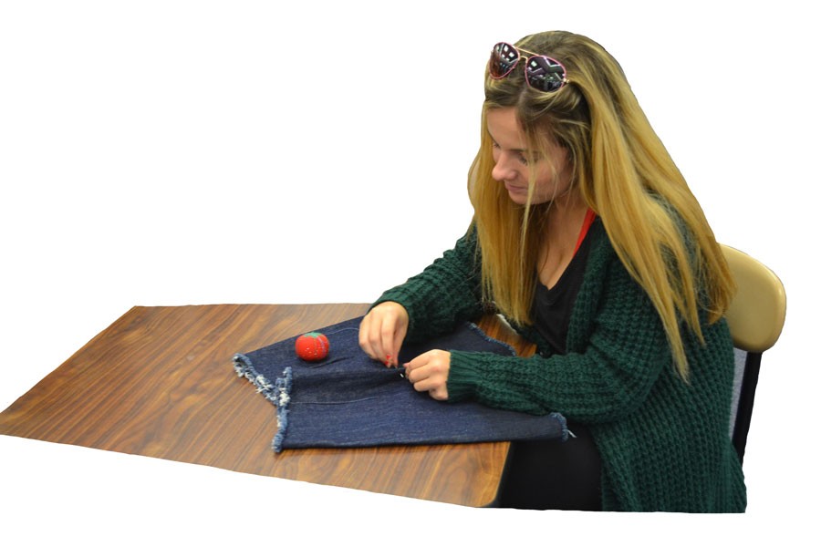 Ellie Richards sews clothing for her new line. 