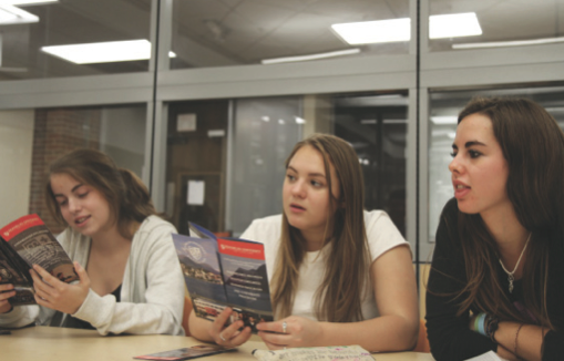 Juniors Lily McCartney, Ellie Rogers and Bailey Bossert listen to a representative from Franklin University Switzerland 