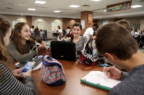 A group of students eat lunch in the South Study Cafe