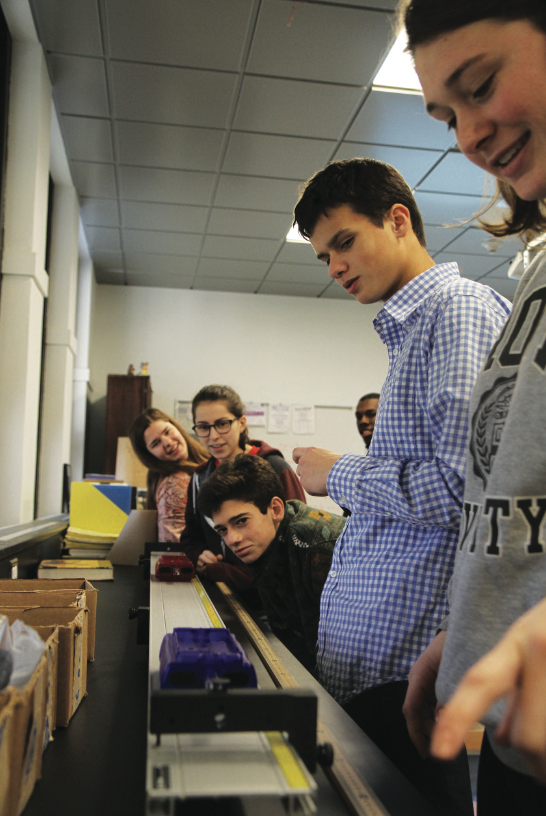 A group of AP Physics students participate in a lab