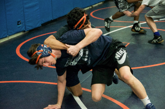 Jack McCleish (bottom) and Chris Rivera (top) wrestle each other at practice