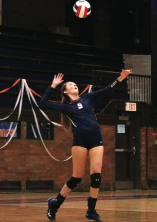 Maya Mahoney serves the ball over-hand to Niles North.