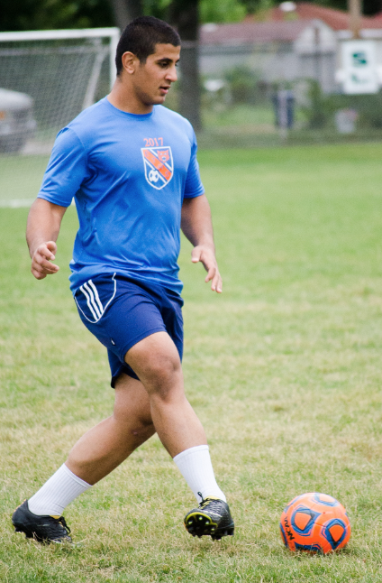 Junior Ramin Abraham passes the ball upfield during practice.