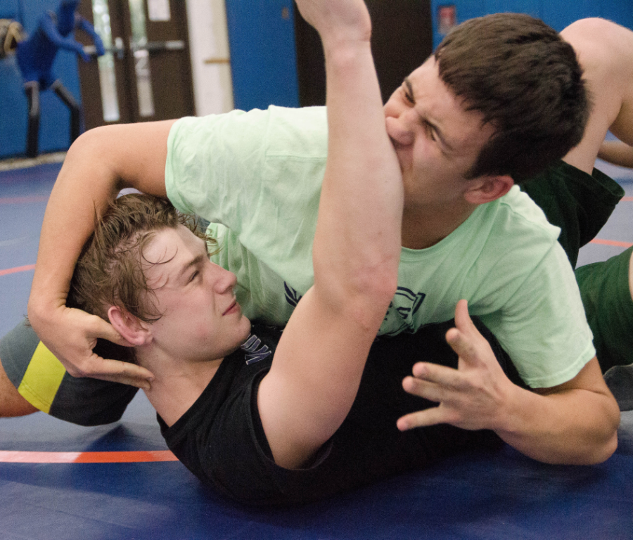 Seniors Van Rutter and Adrian Bytyqi get wrapped up with one another at practice.