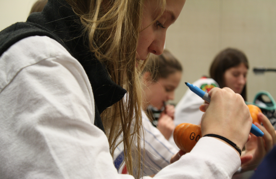 Caroline Chapon decorates pumpkins with inspirational messages.