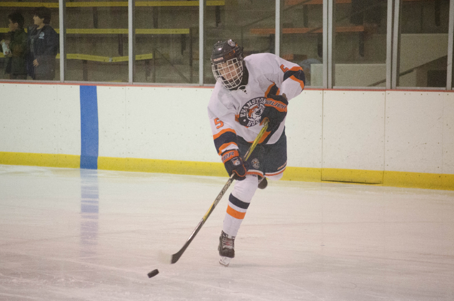 Senior Fritz Gallun moves the puck across the ice.