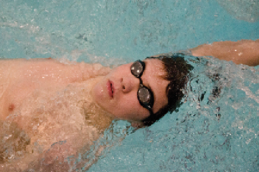 Junior Zach Andalman does the backstroke at practice.