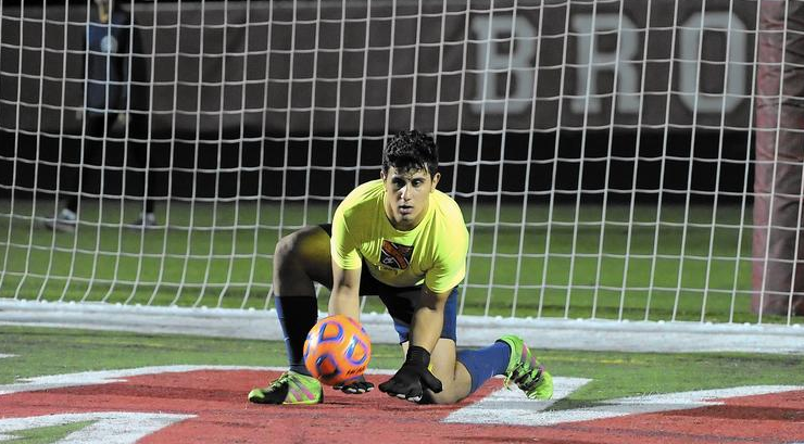 Abraham makes a save during warmups. 