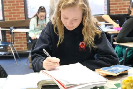 Former St. Athanasius student does classwork after transitioning to public school
