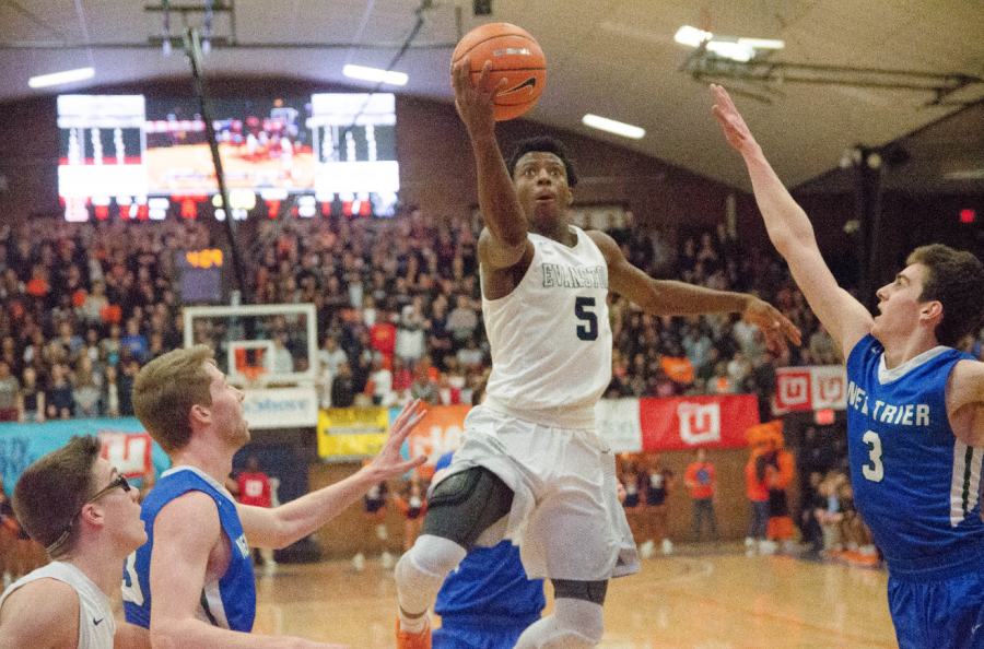 Junior Lance Jones drives through New Trier defenders to score.