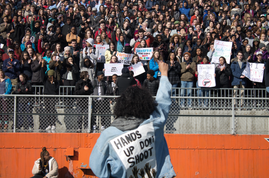 Junior+Liana+Wallace+ends+her+poem+about+the+intersection+of+gun+violence+and+race+by+raising+her+fist.