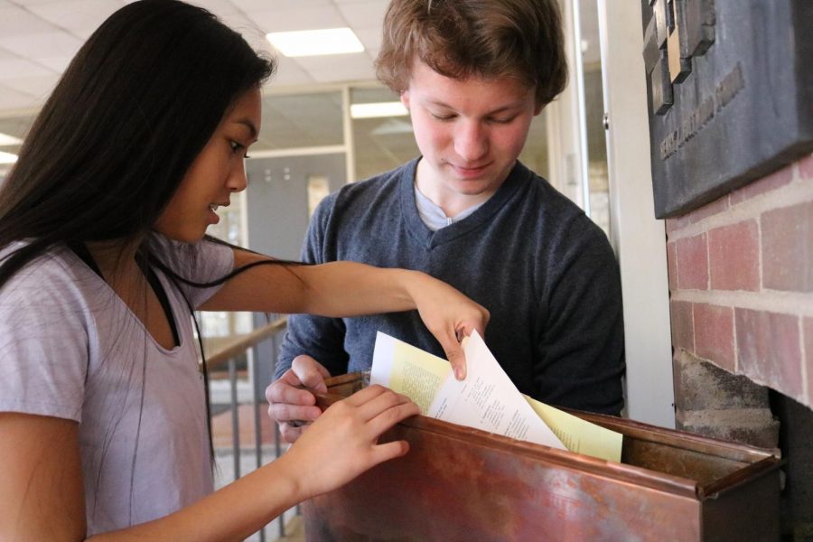 Sophomores Chris Dakich and Danielle Rivera examine the West capsule.