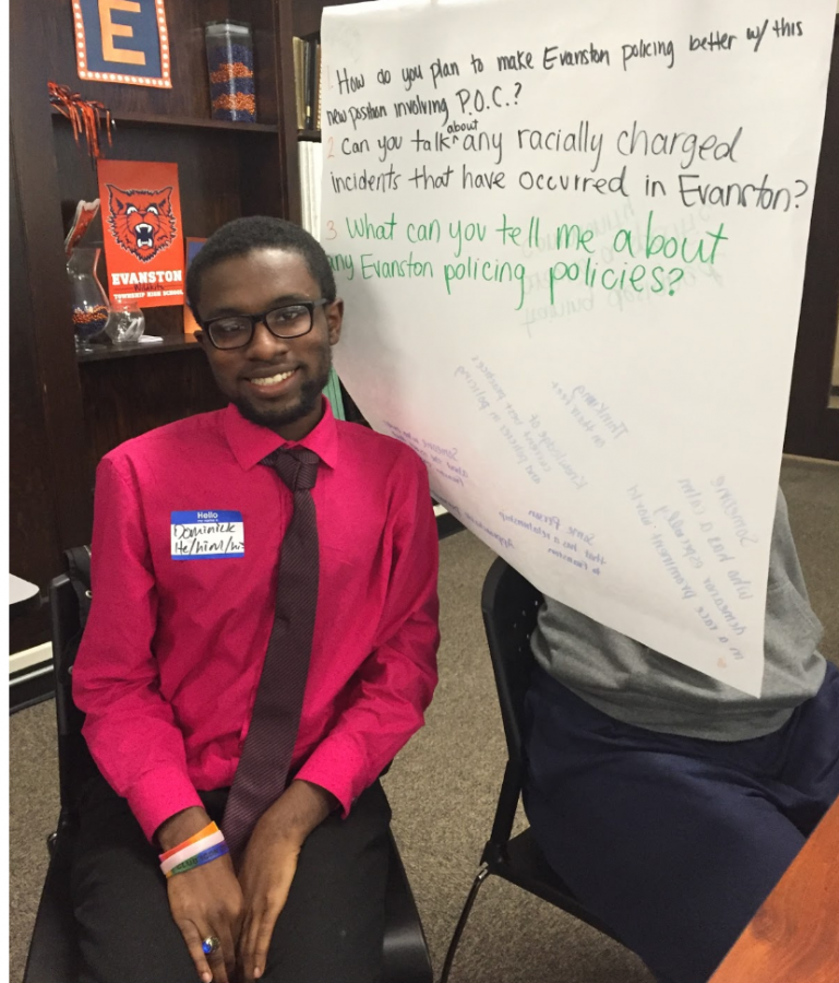 Senior Dominick Mcintosh sits next to group poster at ETHS student discussion on Oct. 16.