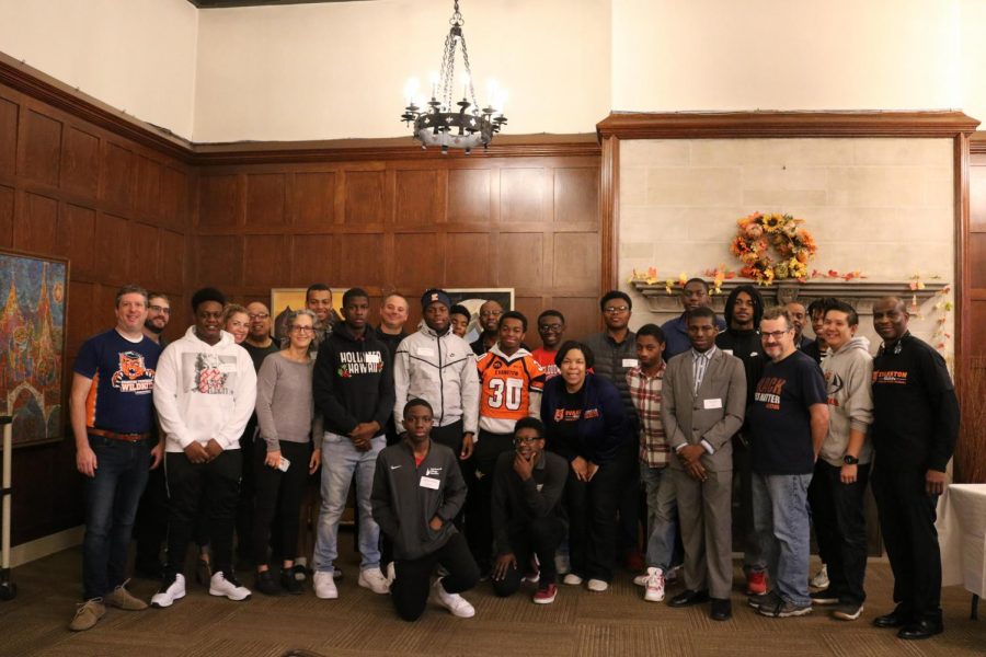 Young males in the program stand with their mentors on Oct. 26.