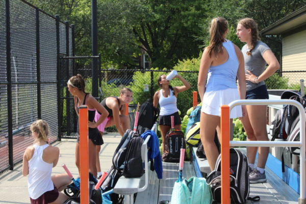 Tennis players prepare for tryouts.