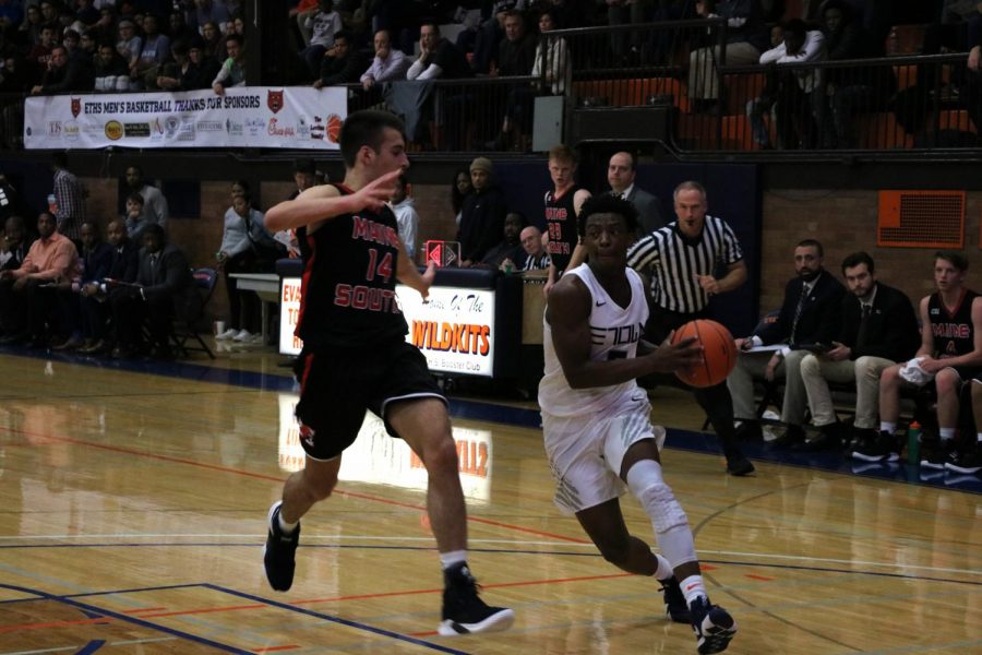 Senior Lance Jones blows by the Maine South defender on his way to the hoop.