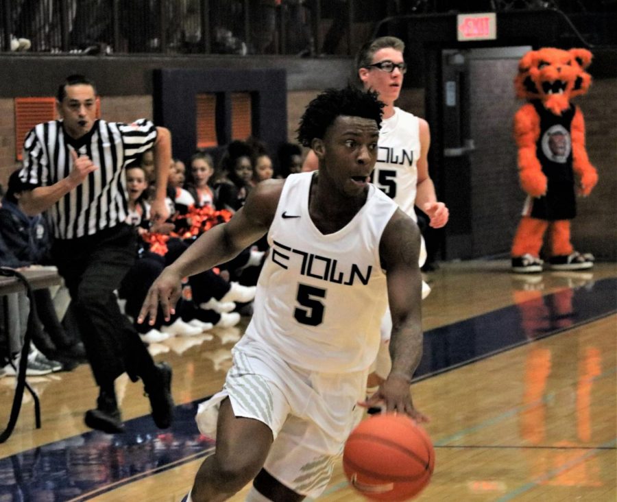 Senior Lance Jones dribbles down the home court of Beardsley Gym.