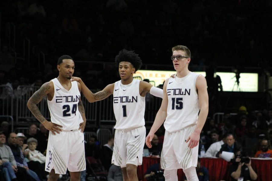 From the left, senior Ryan Bost, senior Jaheim Holden and sophomore Blake Peters discuss strategy during the fourth quarter. 