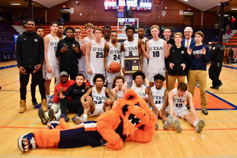 Boys basketball poses with Regional Championship trophy after Friday night win.