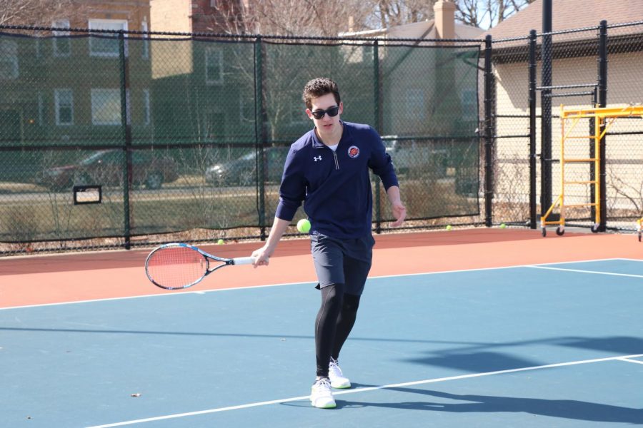 Senior co-captain Max Johnson works on his swing. 