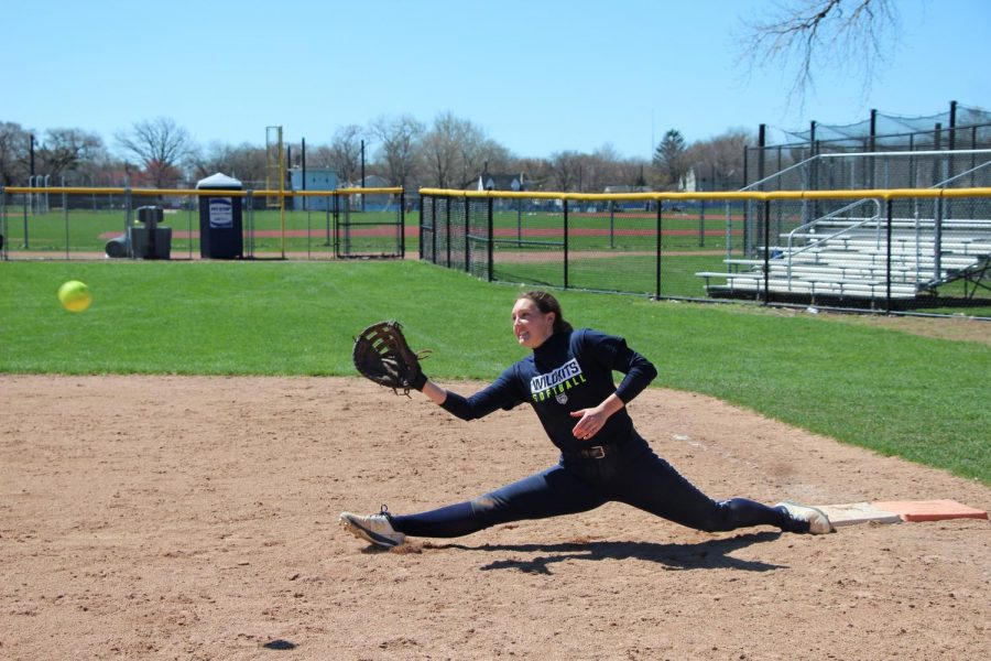 Senior Lucy Hart stretches off of first base.