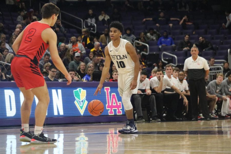 Elijah Bull dribbles the ball up the court