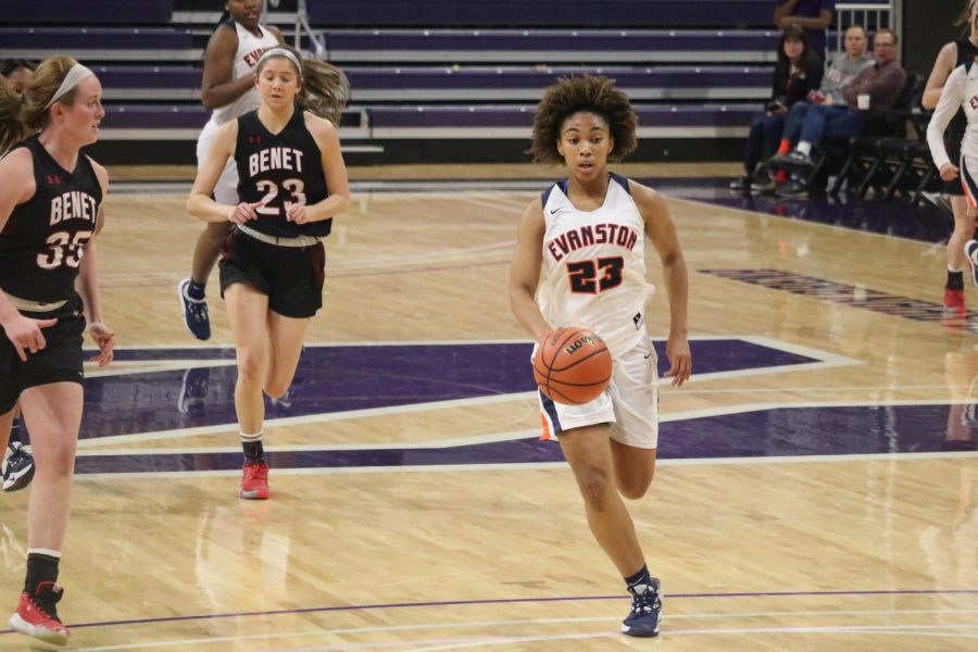 Senior Kayla Henning dribbles ball down the court at last nights game.