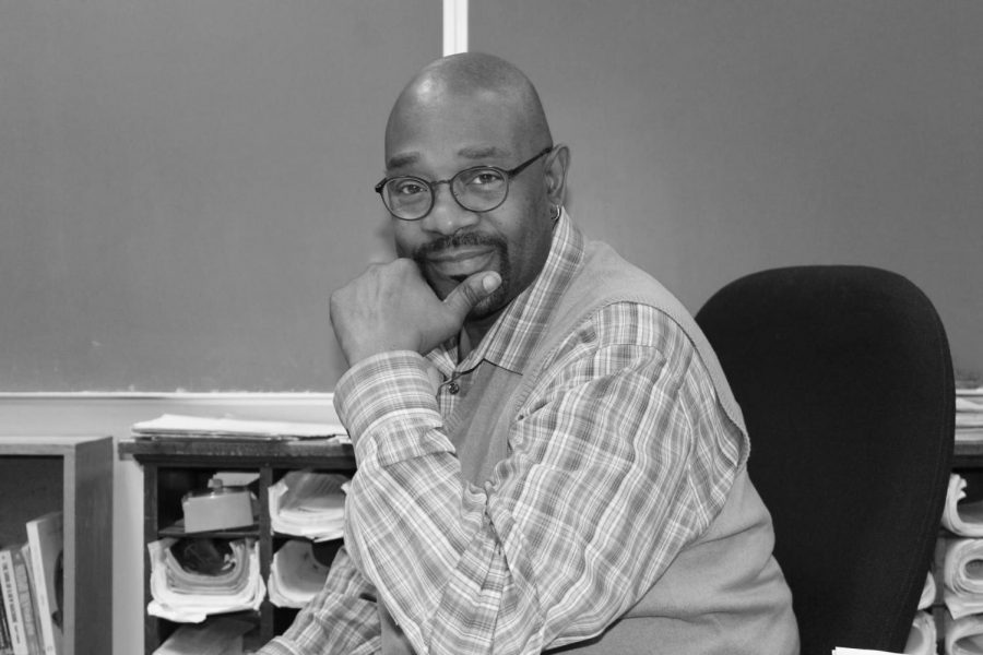 Mr. Lowe sitting behind his desk.