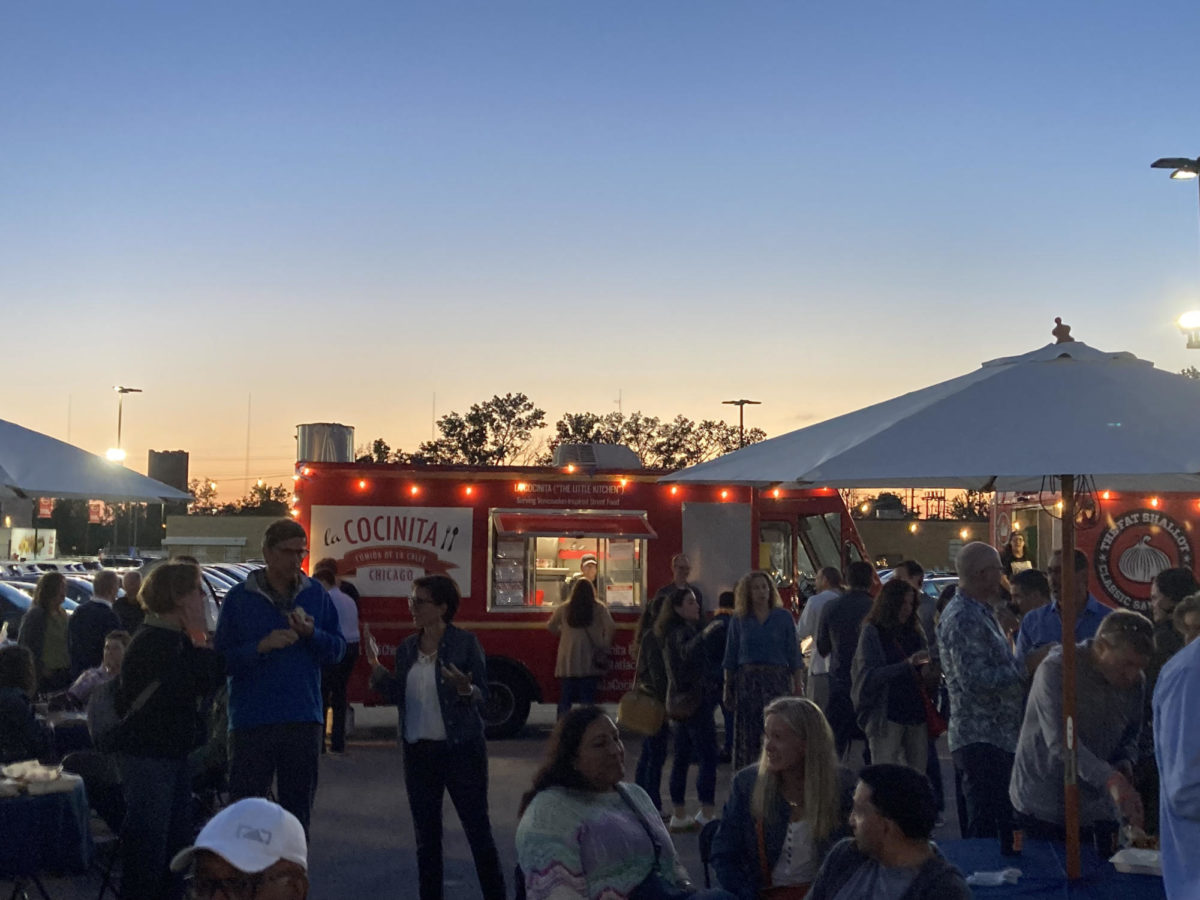 Participants gathered around multiple food trucks at the event.