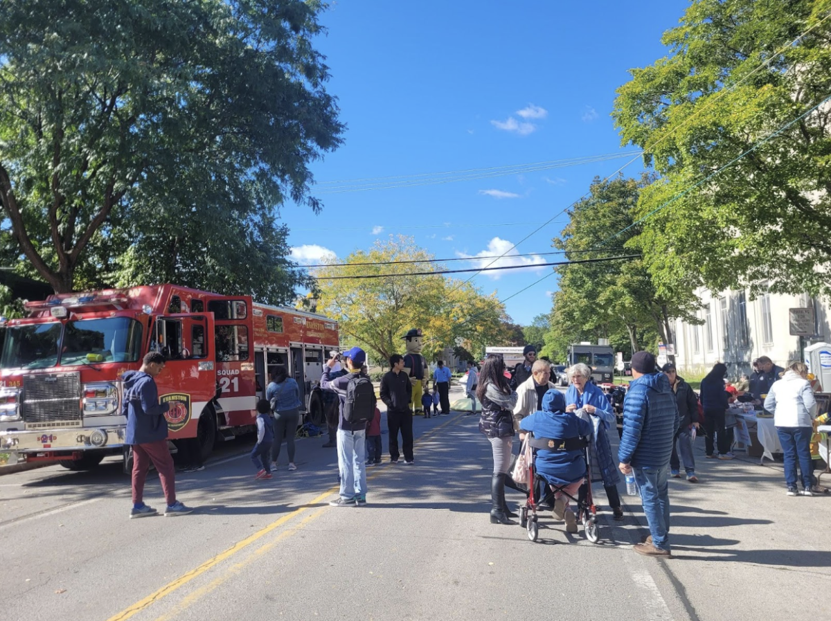 Participants gathered around a fire engine to learn about its functions.