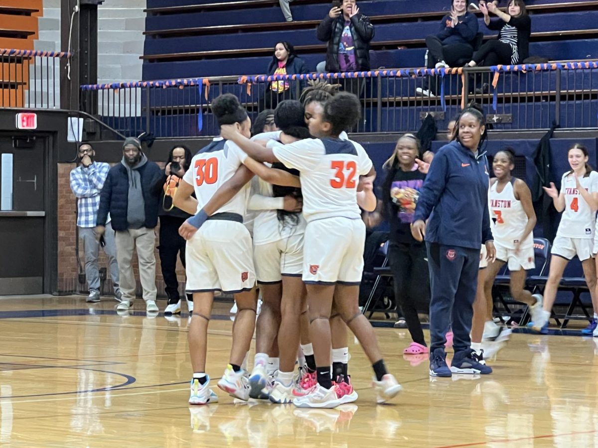 Evanston+players+celebrate+during+their+win+over+Deerfield%2C+71-23.