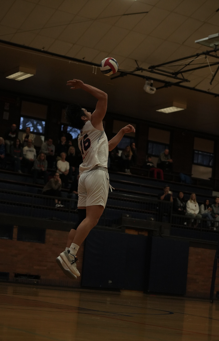 Senior Tyler Tang serves during Evanstons victory over Notre Dame on Tuesday, April 2.