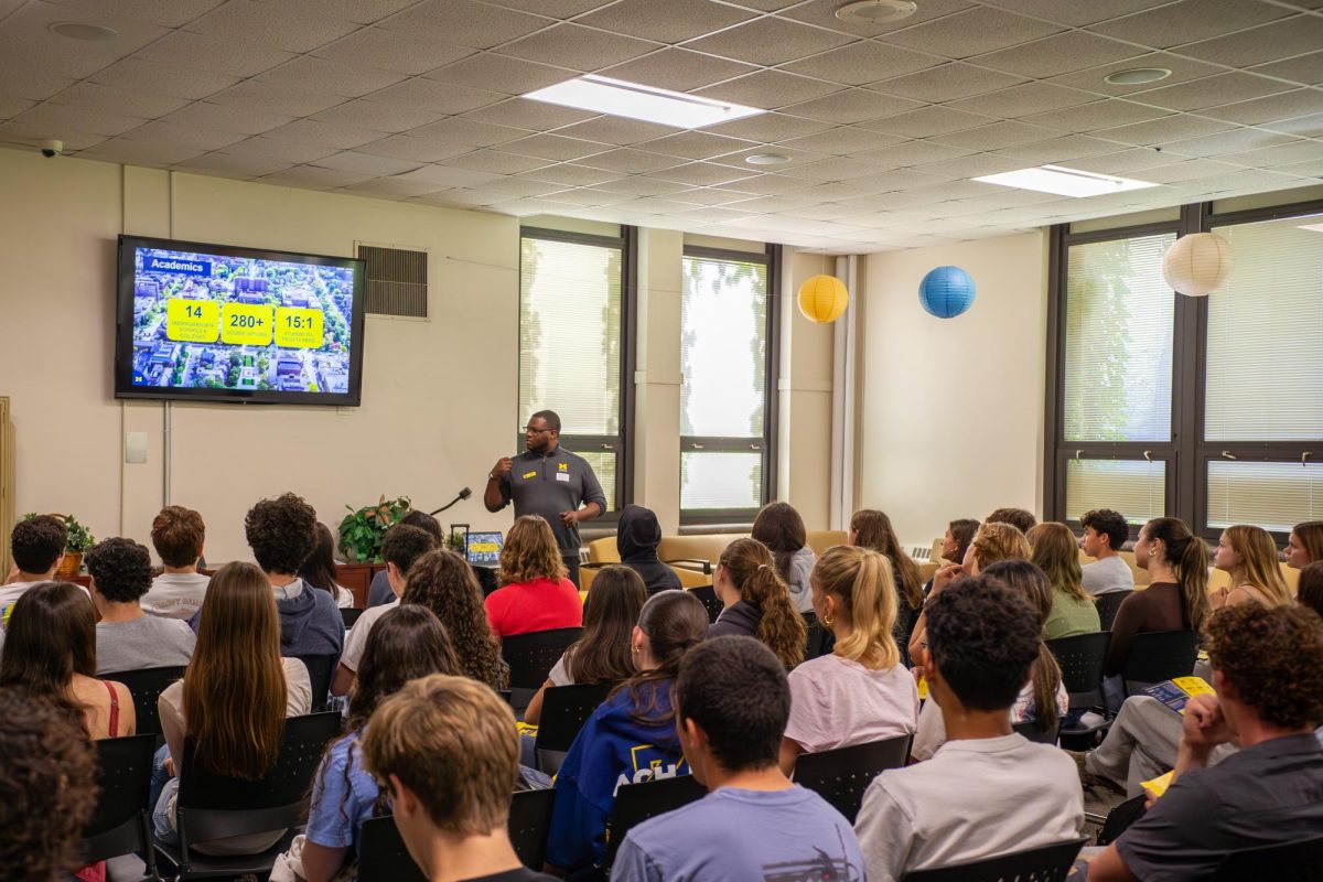 University of Michigan admissions counselor Gregory Lockett speaks to students at Evanston Township High School during an informational presentation about the university.