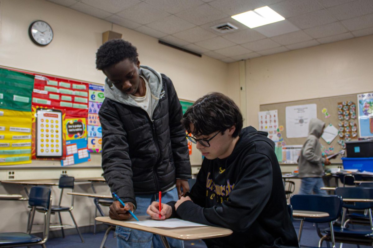 Senior Keegan Manning and Sophomore Papa Sow collaborate on a French assignment.